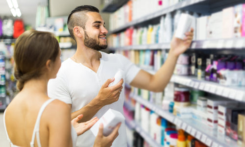 man buying cosmetic cream in store