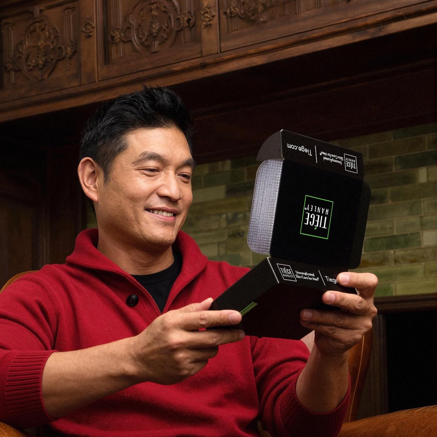 Man holding a box of Tiege Hanley